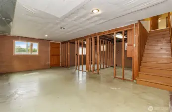 Stairs leading from upstairs to a partially finished basement