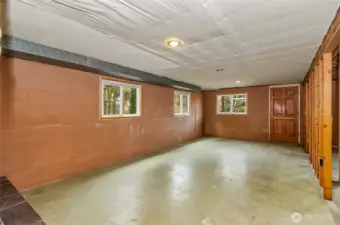 The large double pane windows bring so much light in! The door leads to outside for potential multi generational living options