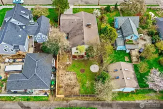 Overhead view of the back of the home showing the alley way access as well as the yard and garden area in this fully fenced back yard