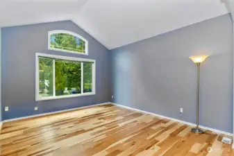 Formal living room with hickory flooring and vailted ceiling.