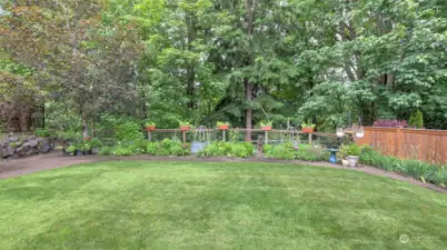 Lush landscaping with perennials returning year after year add to the privacy. All serviced by an added sprinkler system.