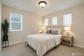 Upstairs corner bedroom + ample natural lighting and generous closet space (Virtually staged)