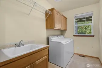 The laundry room has a sink and lots of storage space.  The washer/dryer will remain with the home.
