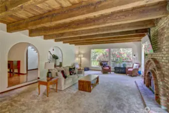 Natural wood beans and fireplace warm the living room