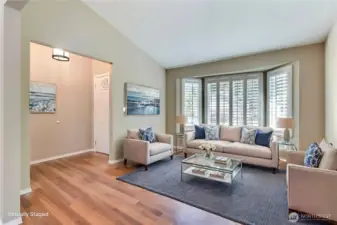 As you enter, you will find to your left a spacious living room. You will love the gorgeous flooring throughout this home, and the cathedral ceilings and large bay windows really open up this space. ***Virtually Staged***