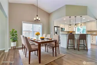 As you walk down the entry hall, you will come to your dining room and kitchen. Love the open concept feel here and the patio doors leading to your backyard. ***Virtually Staged***