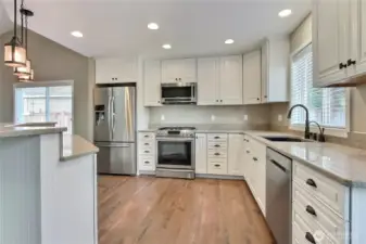 Kitchen view one, LOVE the sold surface counters, all the storage (drawers!!) and matching stainless steel appliances. Handy island as well!