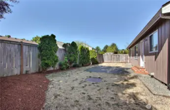 Backyard view, fresh landscaping and new rear stoop. Patio for your set or hot tub. Fully fenced!