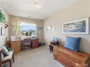 Second upstairs bedroom with bright windows and versatile space