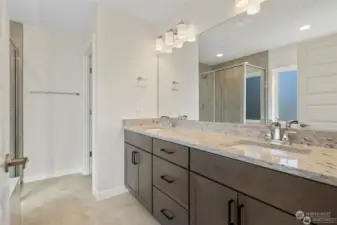 Primary ensuite includes dual sinks, tile surround soaking tub, 5 ft shower with tile wall to ceiling, 6ft glass shower door, separate toilet room, luxury vinyl plank flooring.  *Photos not of actual home - same floor plan in a different community*