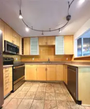 1Love to cook? This modern kitchen is beautifully appointed and offers a generous amount of storage cabinets, drawers and counter space for all your gourmet prep needs. Extra details like full tile backsplash add a nice finishing touch.