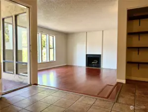 The open living room allows for many different options on arranging furniture and a wood-burning fireplace adds to the ambiance.