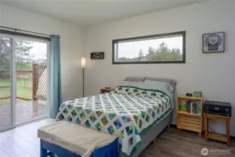 Guesthouse bedroom looking out toward back deck and firepit