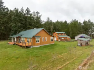 Main house on left, barn in middle, guest house and woodshed on right