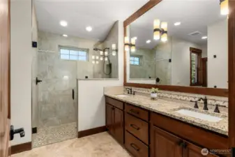 Heated floor and beautiful walk-in shower in primary bathroom.