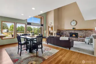 Dining space in kitchen adjacent to living room with oak hardwood floors.