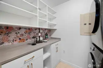 Upgraded by the seller to provide extra pantry space in the butler pantry/laundry room. Great place for a coffee bar.