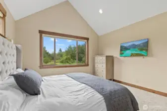 Primaray Bedroom With Vaulted Ceilings and Large Picture Framed Window