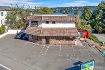 Office space below with 1/2 bath. 2-bed/1-bath above. 9 parking spaces!