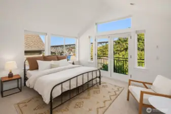 Primary suite bedroom with vaulted ceilings.