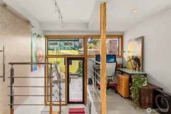 Large wall of windows connects the indoors & outdoors - making a cozy spot to get work done at home