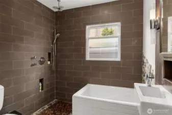Japanese soaking tub fits cozy in the remodeled bathroom - featuring stunning full tile surround finish