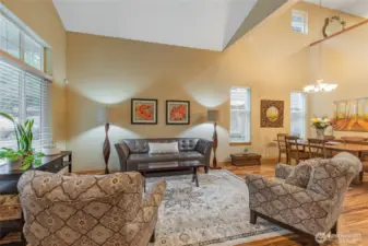 Soaring vaulted ceilings and expansive windows create a grand sense of space in the formal living room.