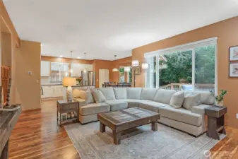 The heart of the home: a sprawling open-concept family room that flows directly into the chef's kitchen. High-end finishes and sightlines to the outdoor deck make this the ultimate hub for daily life.