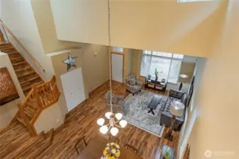From the upper-level overlook, take in the breathtaking scale of the home’s architecture. This vantage point highlights the soaring vaulted ceilings and the seamless flow between the formal living areas below, emphasizing the home's open and bright design.
