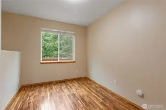 Perfect for multi-generational living or a private home office, spacious main-level bedroom. Its convenient location near the powder room provides an ideal setup for guests or long-term visitors.