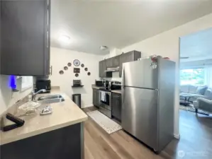 Beautiful kitchen with great appliances with elegant luxury vinyl plank flooring.