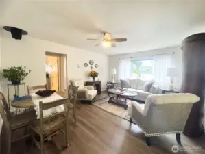 Living room offers lots of space and Luxury Vinyl Plank flooring. The open concept design creates a bright and inviting atmosphere, perfect for relaxation and entertainment.