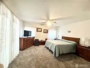 Primary bedroom is gorgeous and huge. The room features ample natural light, creating a bright and inviting atmosphere. The spacious layout offers plenty of room for comfortable living and relaxation.