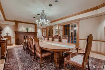 Formal dining area with fireplace, built-ins and access to catering space/butler pantry.