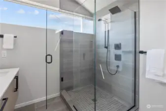 A luxurious walk-in shower with modern tiles and high-end fixtures, perfect for relaxation.