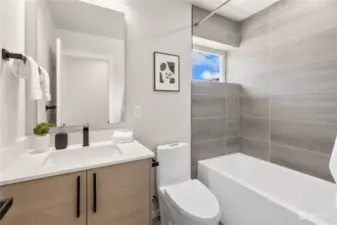 Contemporary bathroom with a sleek design and natural light.