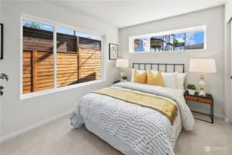 Cozy and bright bedroom with large windows for natural light.