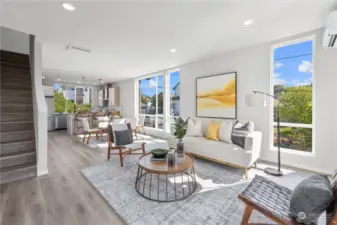 This spacious open-concept layout seamlessly connects the living room to the modern kitchen, perfect for hosting friends and family.