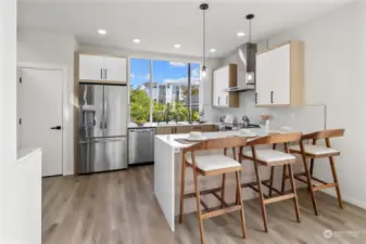 The kitchen boasts modern finishes, stainless steel appliances, and ample counter space, making it perfect for culinary creations.