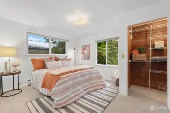 This bedroom is a peaceful and inviting space, with natural light pouring in through the window, creating a bright and airy atmosphere.