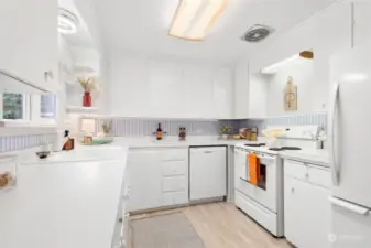 Crisp, clean countertops and cabinetry provide a fresh, airy feel, making the space perfect for cooking and gathering.