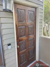 Beautiful solid wood front door welcomes you home.