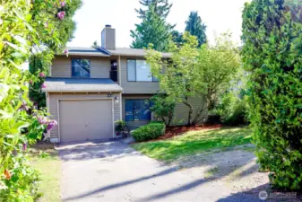 View as you pull in to the driveway. Enter house from front door or through 1-car garage, or follow the path on the left side around to the backyard.