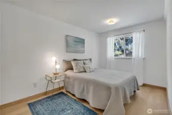 Larger bedroom at the rear of the home with custom interior wood door and glass doorknobs!