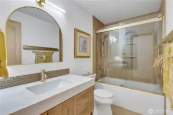Beautifully updated  Clark deep soak air tub and custom glass tile accents in bathroom with Bluetooth equipped fan...