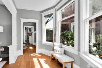 Gorgeous fir floors, high ceilings, windows galore, and beautiful period details can be found throughout the entry, living, and dining.