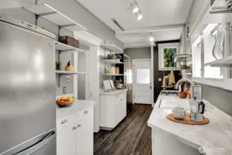 This eat-in kitchen is packed with storage and counter space. Back door leads to the sweet brick patio.