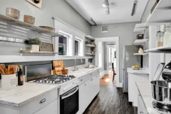 This eat-in kitchen is packed with storage and counter space. Back door leads to the sweet brick patio.