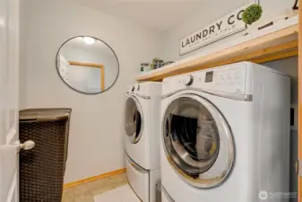 well thought out utility room, with storage shelf above the washer/dryer