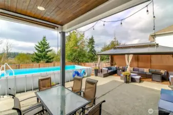 custom covered outdoor space with tongue and groove ceilings complete with can lighting
